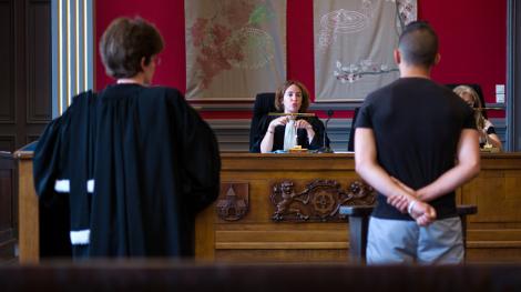 A judge speaks to a youth during a hearing at the children's court in Mulhouse on June 26, 2013. AFP PHOTO / SEBASTIEN BOZON